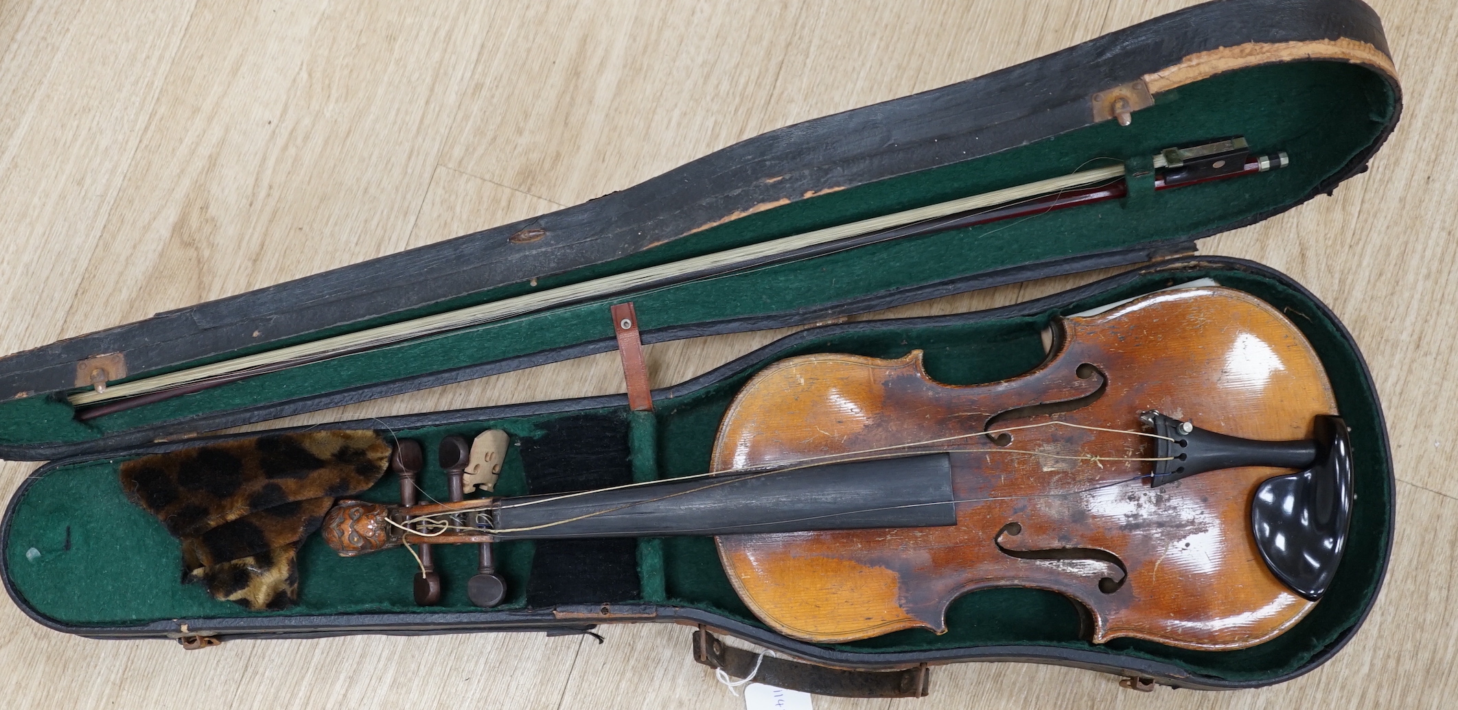 A cased 19th century Continental violin with lions head carved scroll, length of body, 35.5cm, with bow CITES Submission reference T5V8RCZY